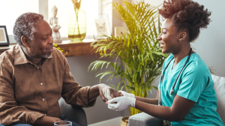 Closeup of a support hands. Closeup shot of a young woman holding a senior man&#039;s hands in comfort. Female carer holding hands of senior man