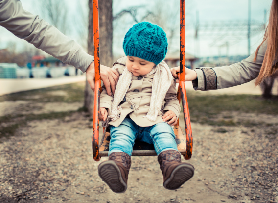 Child sitting on swing