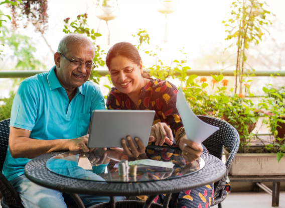 Older couple with computer older couple sitting outside with a computer
